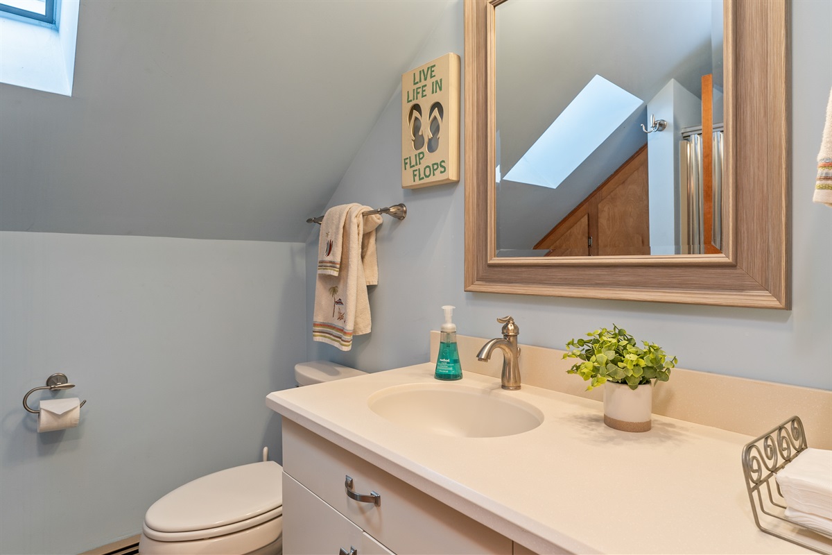 Clean, modern bathroom with natural light, fresh towels, and all essentials for a comfortable stay.