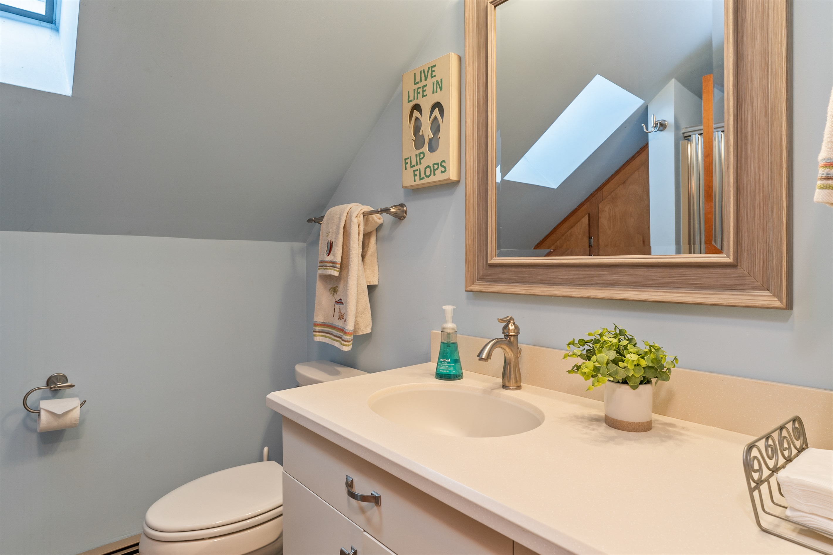Clean, modern bathroom with natural light, fresh towels, and all essentials for a comfortable stay.