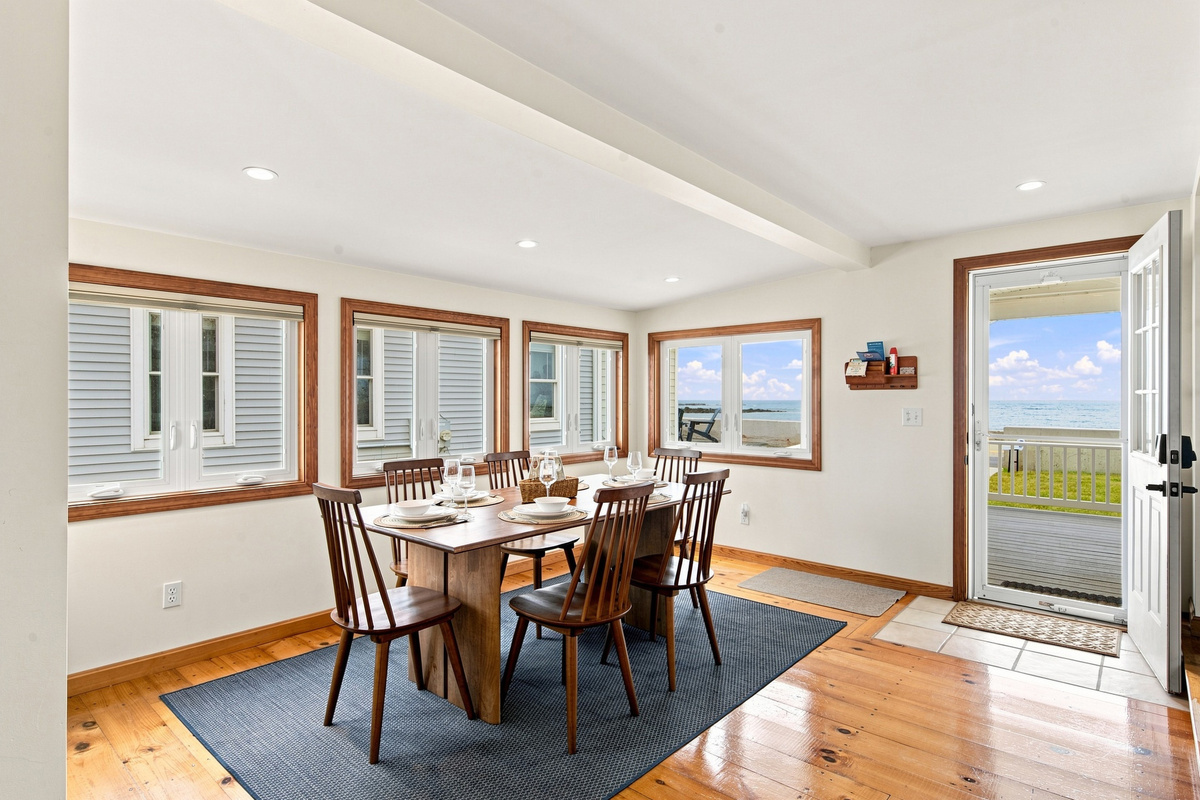 Bright dining area with easy access to the deck and beautiful ocean views.