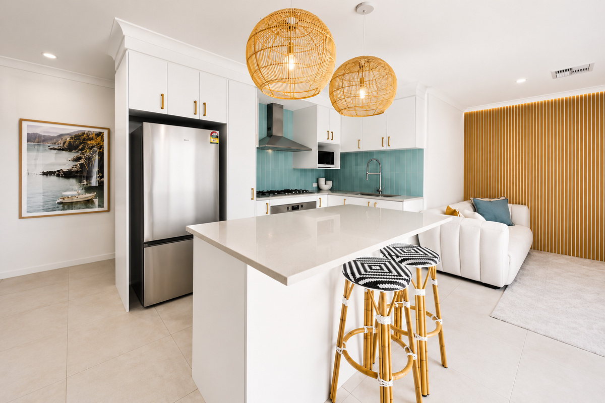 The kitchen island at The Duchess of Duke adds bench space and two stools, tying the kitchen into the open-plan dining area.