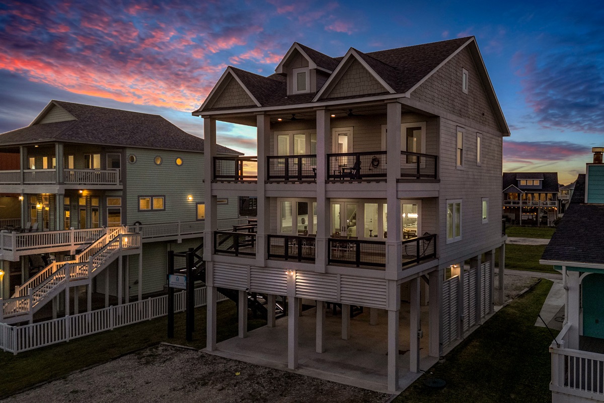 Costa Cristal Exterior: Experience the grandeur of this luxurious home, where striking architecture and clean lines create a bold, modern statement. Expansive terraces invite you to enjoy the views. 