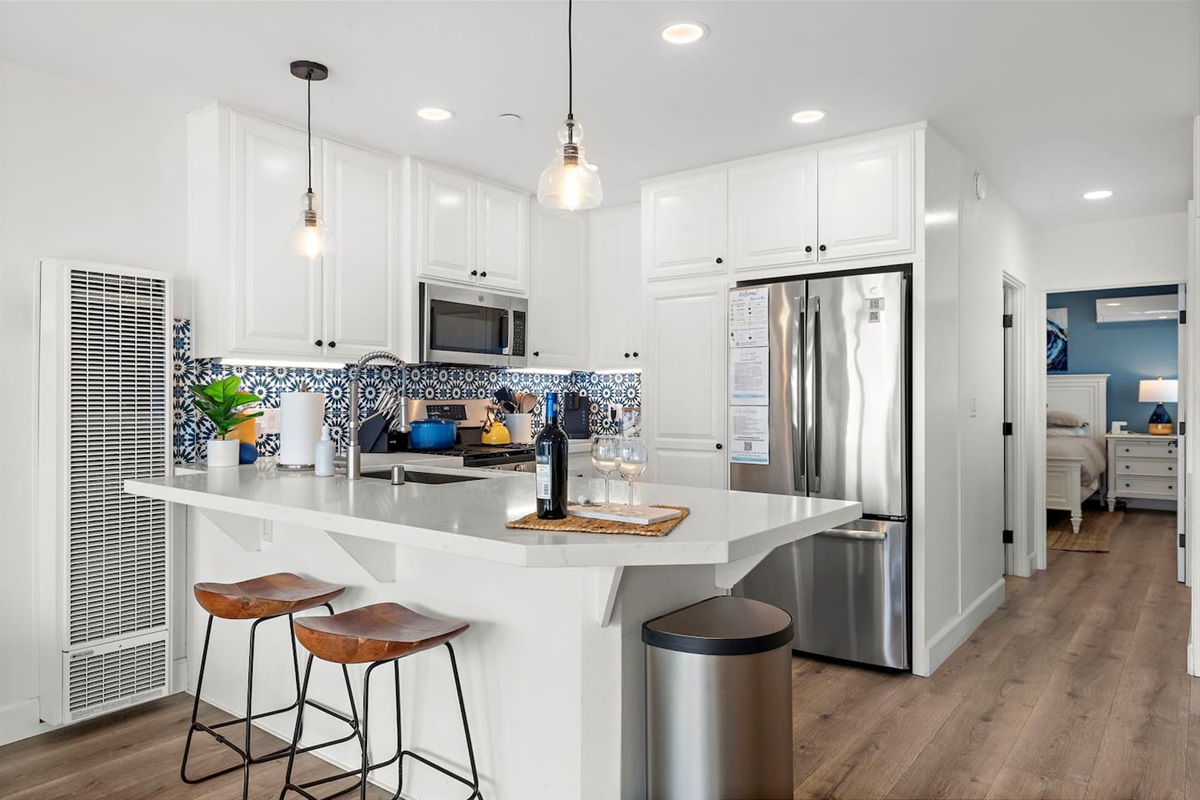 The bathroom is located down the hallway on the left side and the bedroom at the end of the hallway.