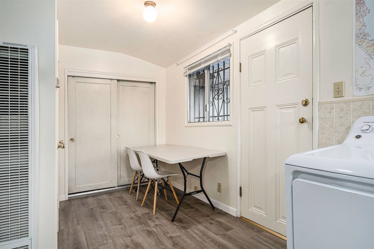 In the laundry room there's a large folding table, ironing board, and board games in the closet.