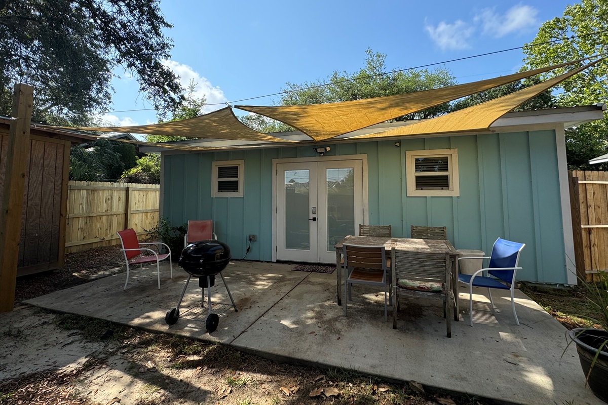 Back patio area with table and grill