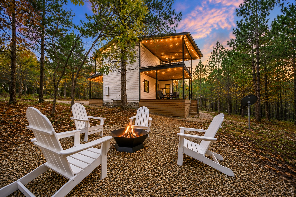 Outdoor firepit nights behind the cabin just feel different.
Tucked beneath the trees with glowing skies overhead and the cabin shining in the background, this is the kind of escape you’ll wish lasted longer.