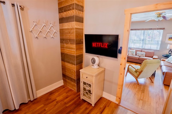 Daybed room featuring a smart TV, hardwood floors, and a walk-in closet. Conveniently located just off the living room.