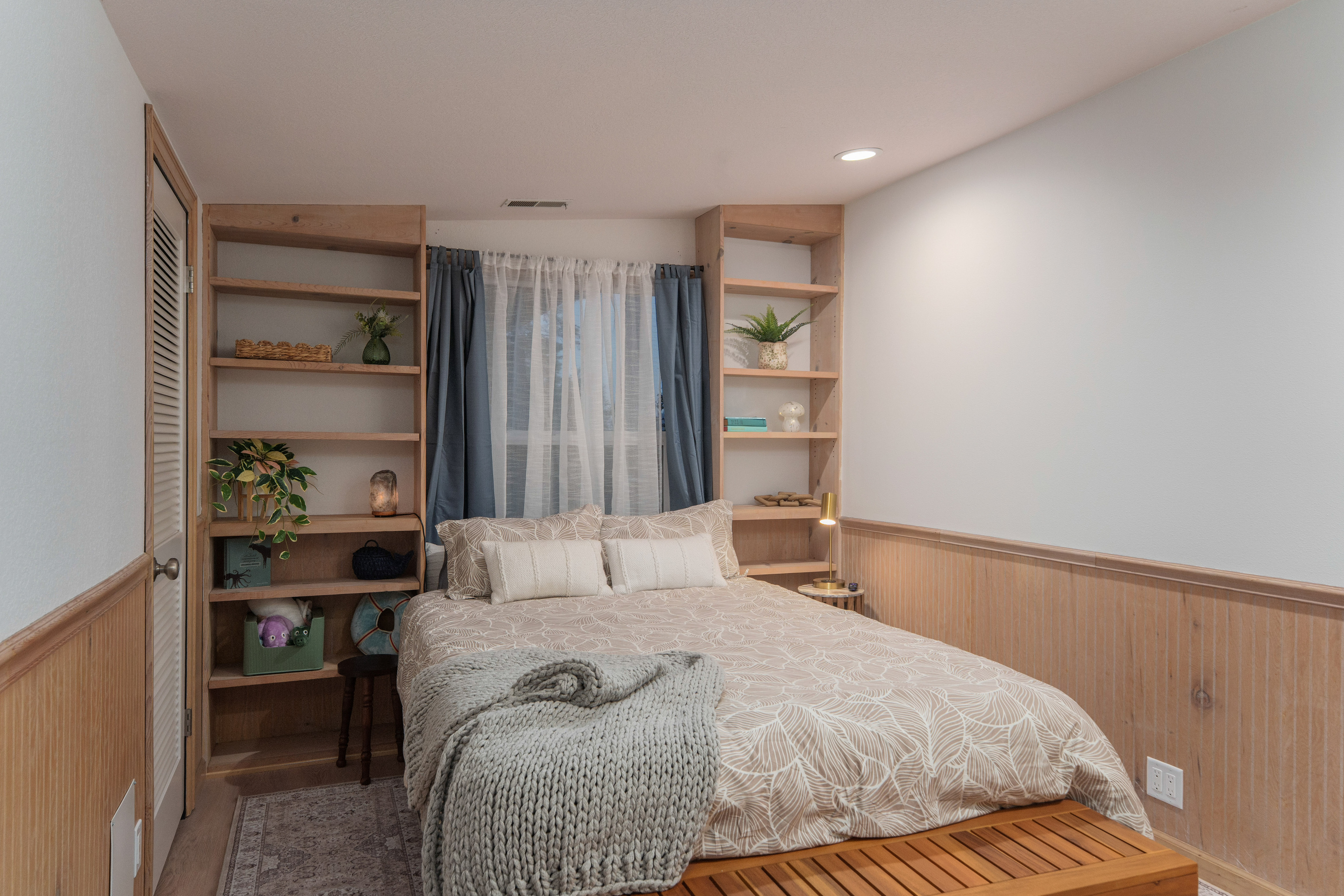 Bedroom 3 offers a comfortable queen bed for two, built-in shelving, and direct access to Bathroom 3, which is shared with Bedroom 4.