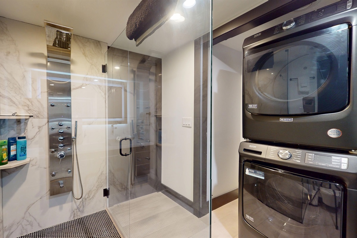 Walk-in Shower with multi-sprayer system as well as stackable washer and dryer.