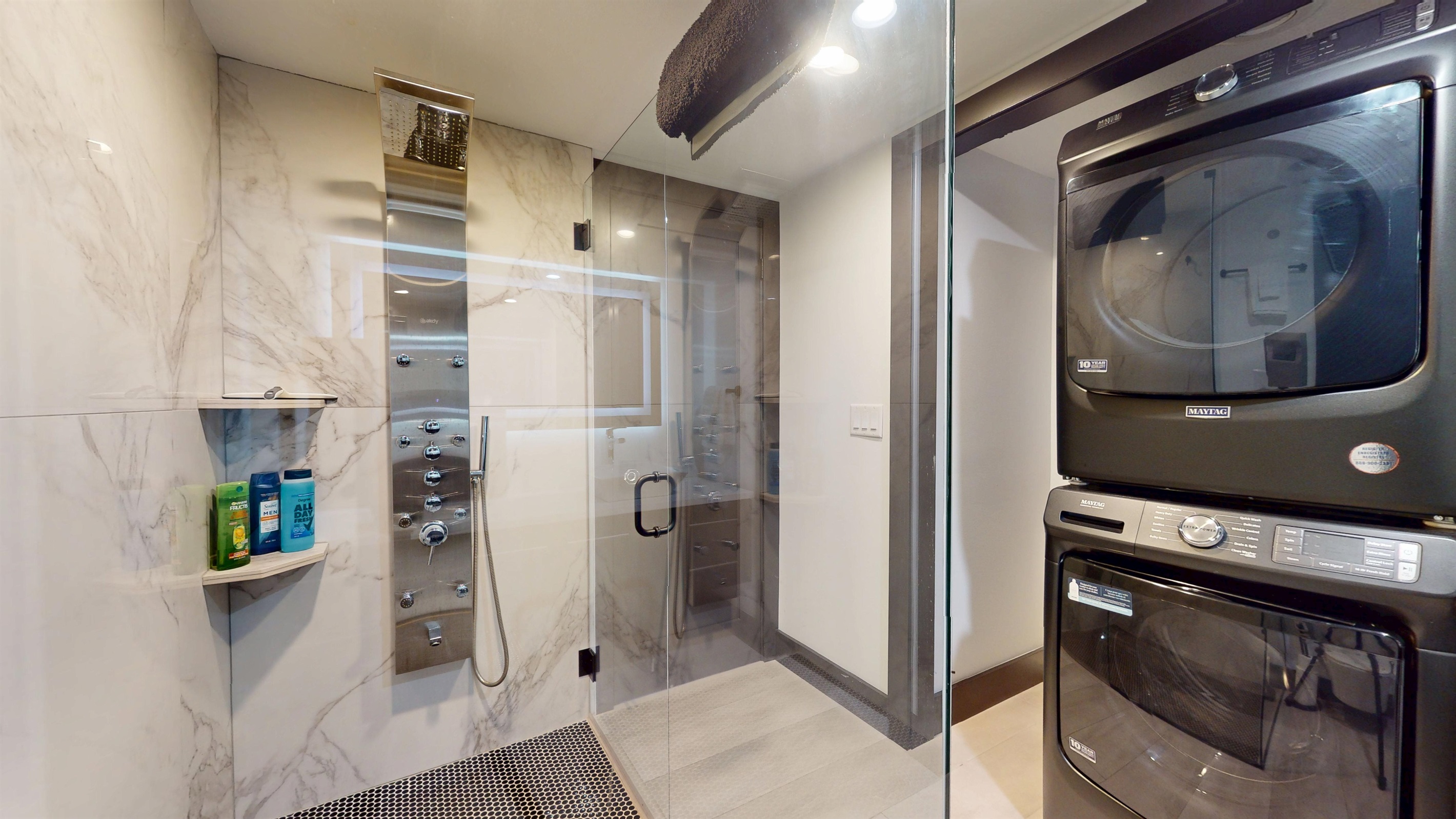Walk-in Shower with multi-sprayer system as well as stackable washer and dryer.