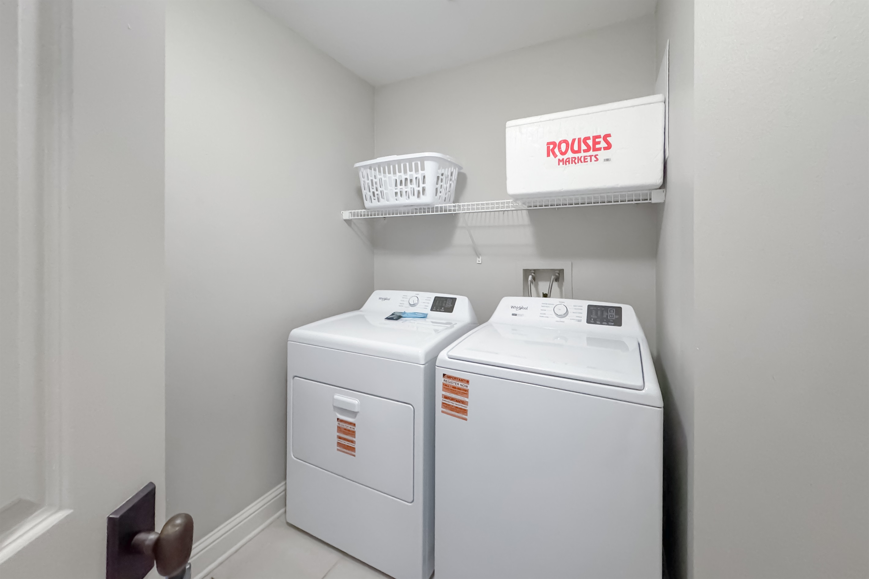 Maximize your comfort with this functional laundry area, featuring an in-unit washer/dryer and wire shelving for organized storage.