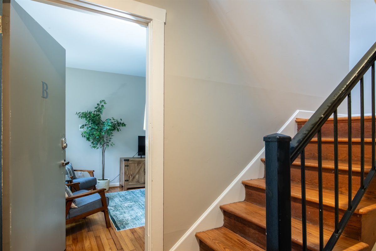 Fresh and simple hallway view, with access to the main living spaces and charming decorative touches.