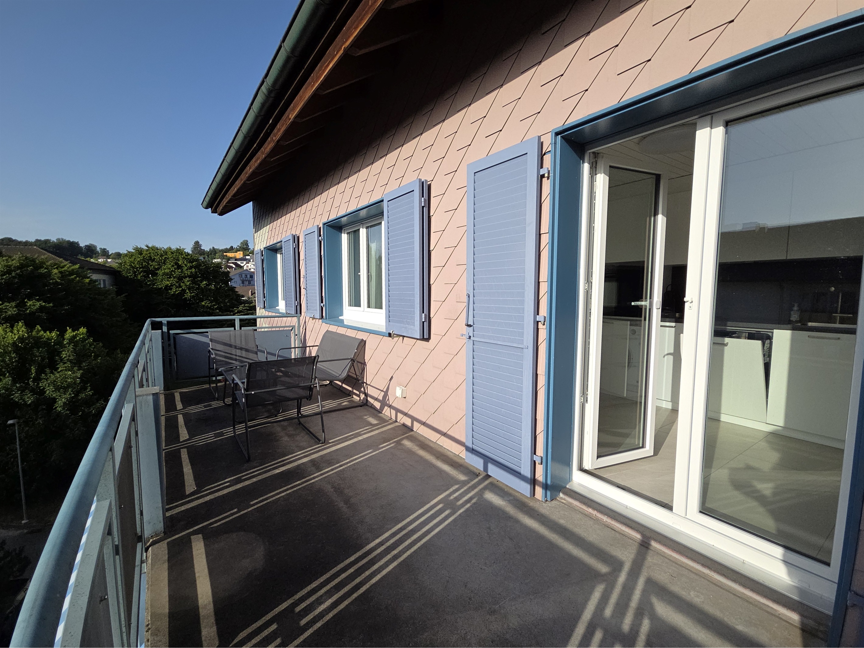 The large balcony is next to the kitchen and living room