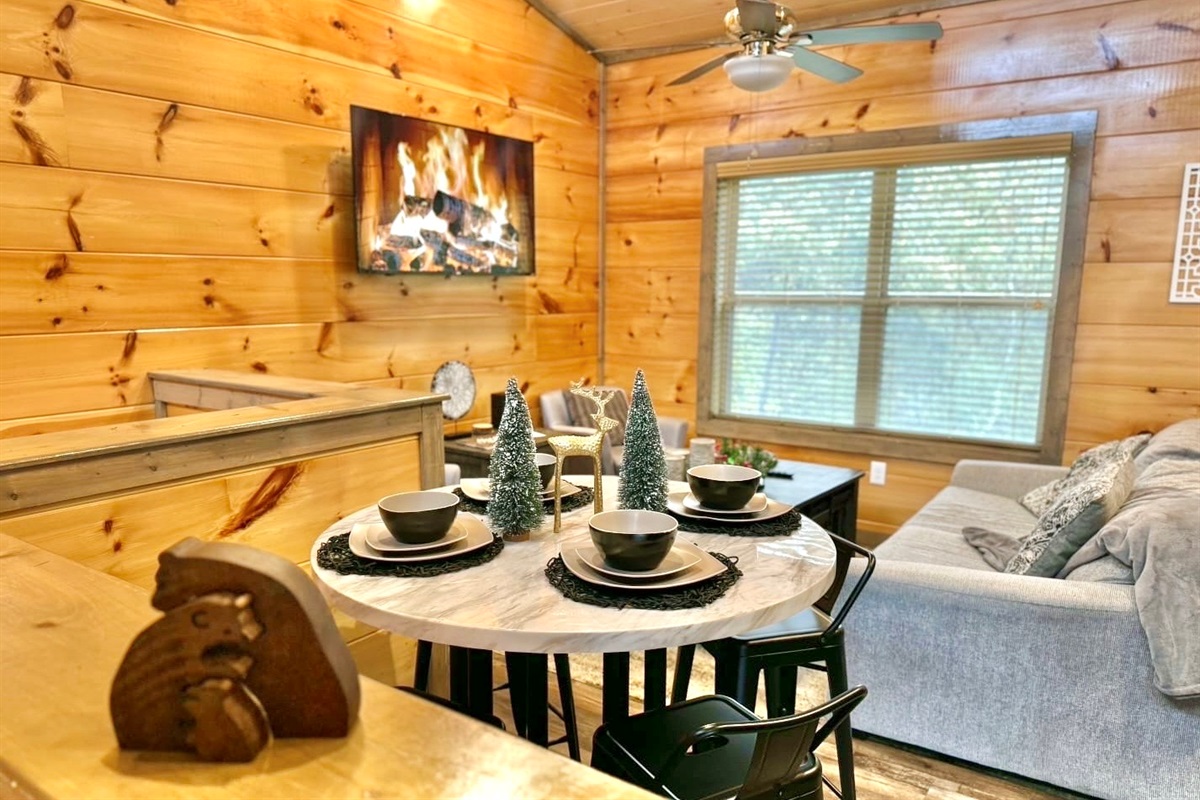 Share a holiday meal beneath the soft glow of the fireplace, surrounded by rustic charm and a space designed for connection and comfort.