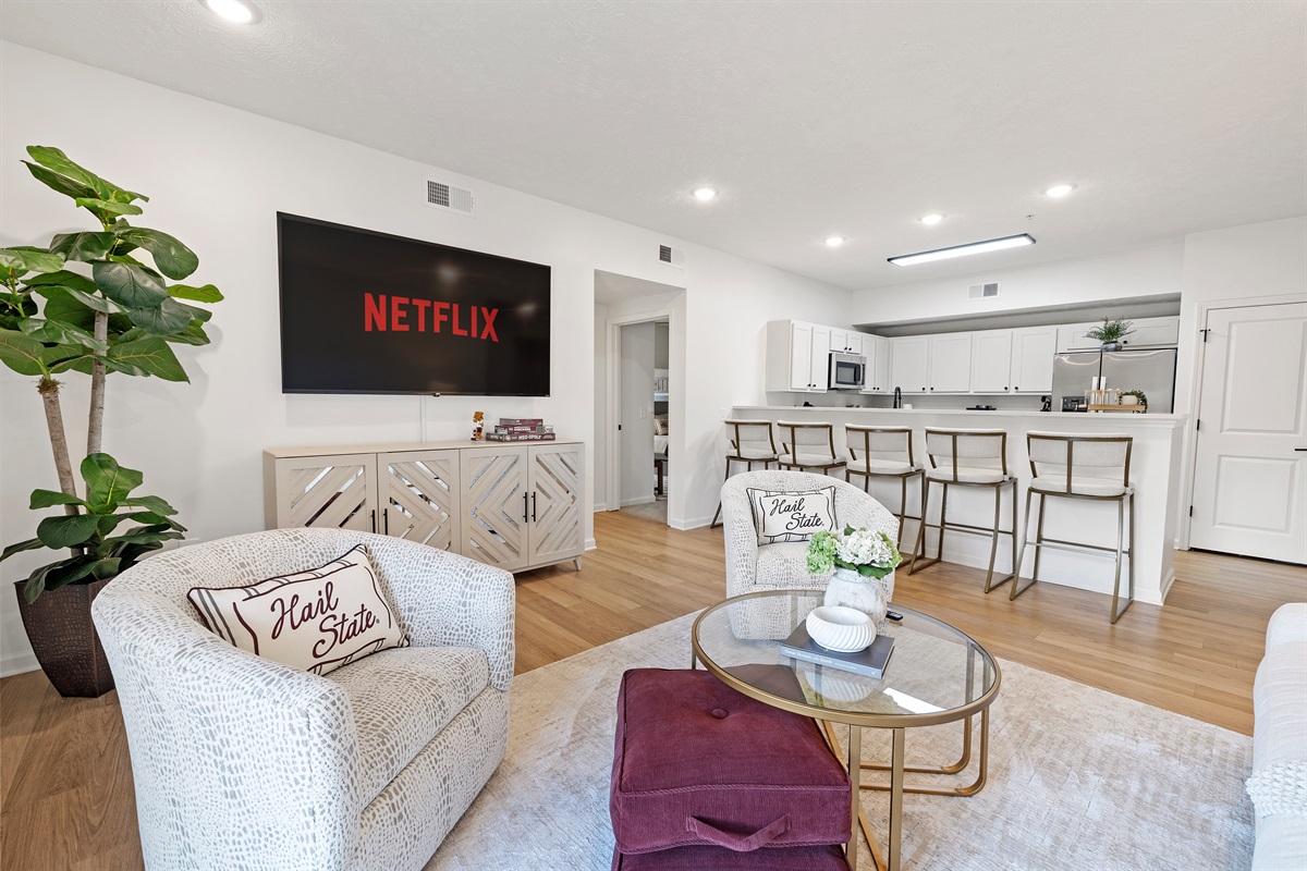 Bright, open living space with a fully equipped kitchen and bar seating for the whole group.