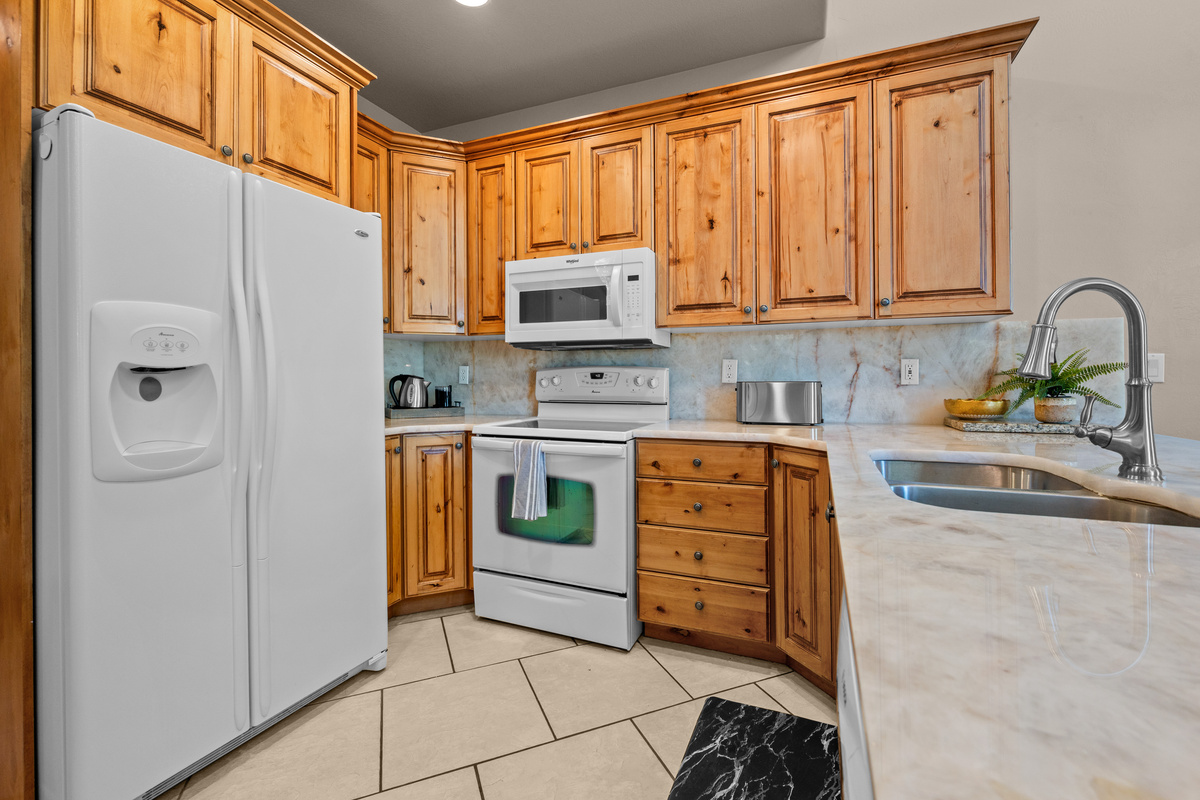 The fully equipped kitchen offers warm wood cabinetry, generous counter space, and everything you need to prepare meals and gather with family and friends during your mountain getaway.