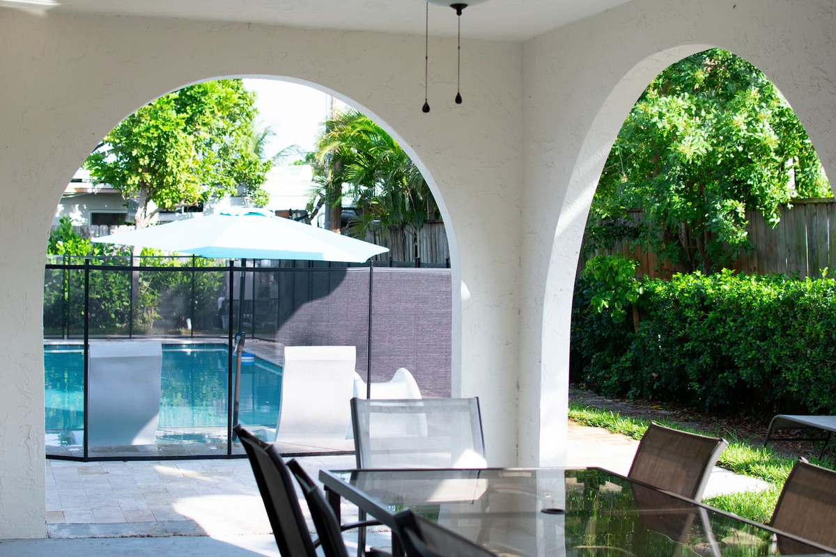 Pool view from veranda with dining setup