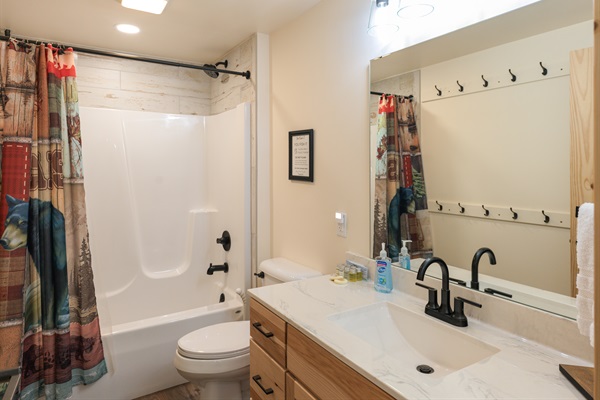 Convenient full bath downstairs — includes toiletries and fresh towels.