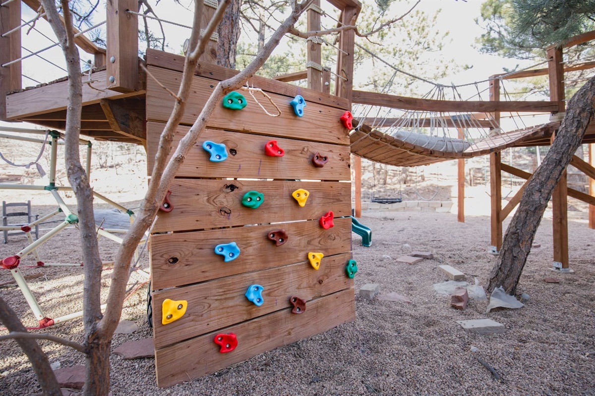 A backyard climbing wall offers a fun and safe adventure space just for kids. Featuring colorful handholds and a sturdy design, it’s perfect for outdoor play!