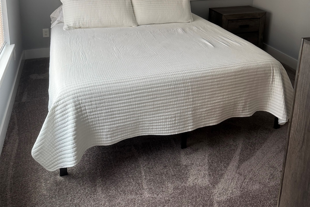 Lower level King bedroom. Shares bath with bunk/queen room.