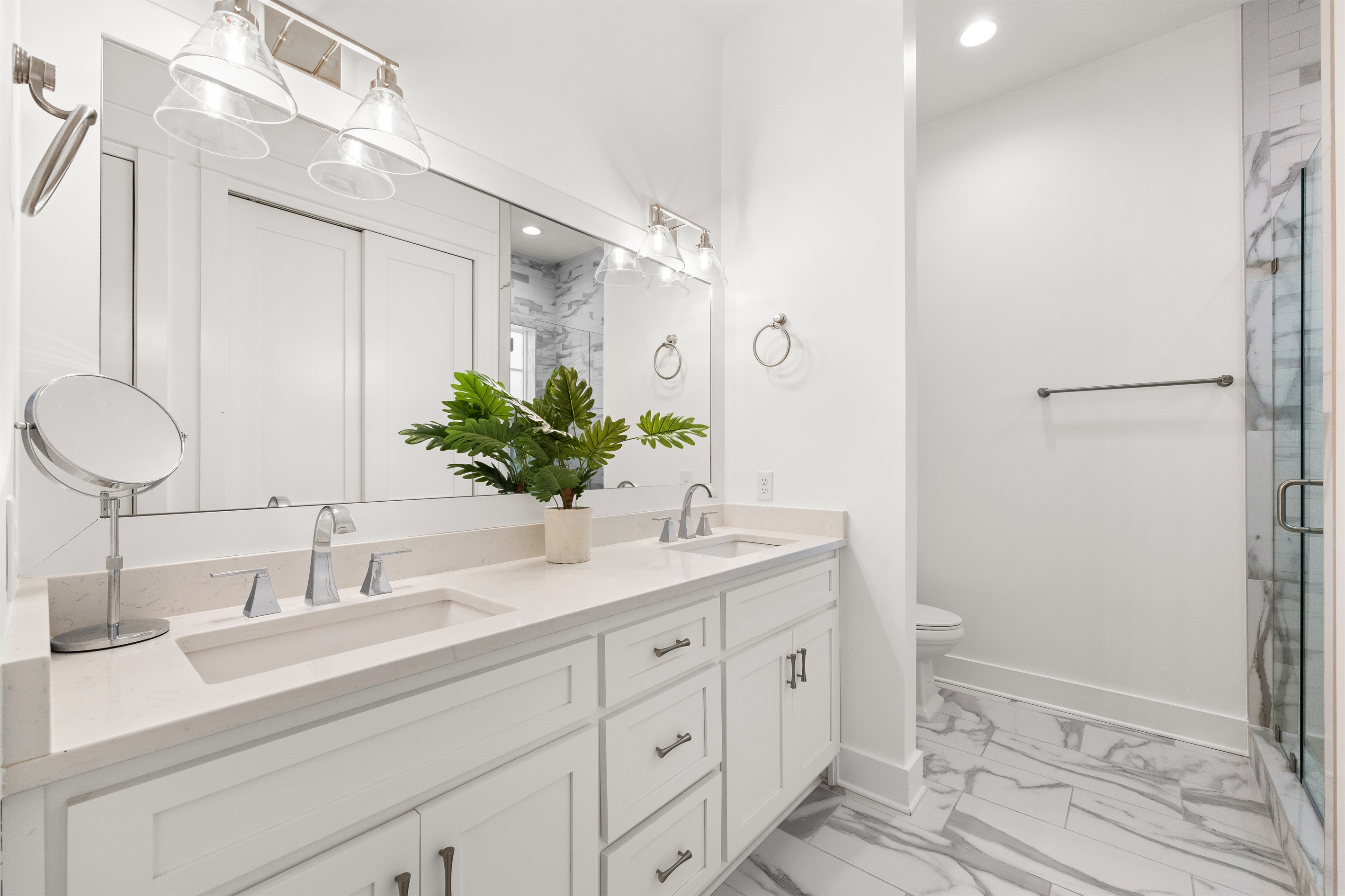 This private ensuite bathroom features bright finishes, generous space, and a clean coastal design for a refreshing start or end to your day.