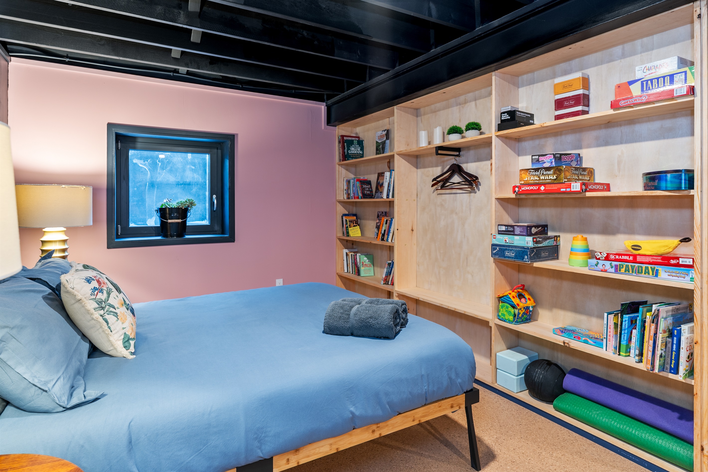 Bright bedroom with built-in shelving, cozy décor, and thoughtful details—ideal for longer stays.