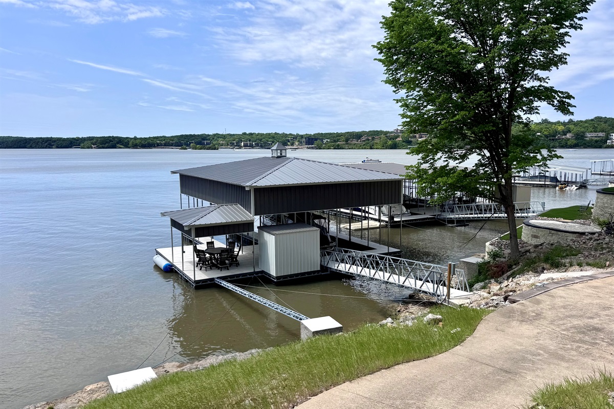 New concrete dock with slip for Guests to use, seating area.