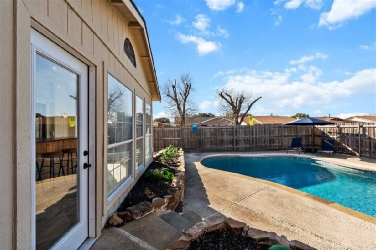 Dive into vacation mode in your private backyard oasis—spacious, fenced, and complete with a sparkling pool and lounge chairs for sun-soaked relaxation.