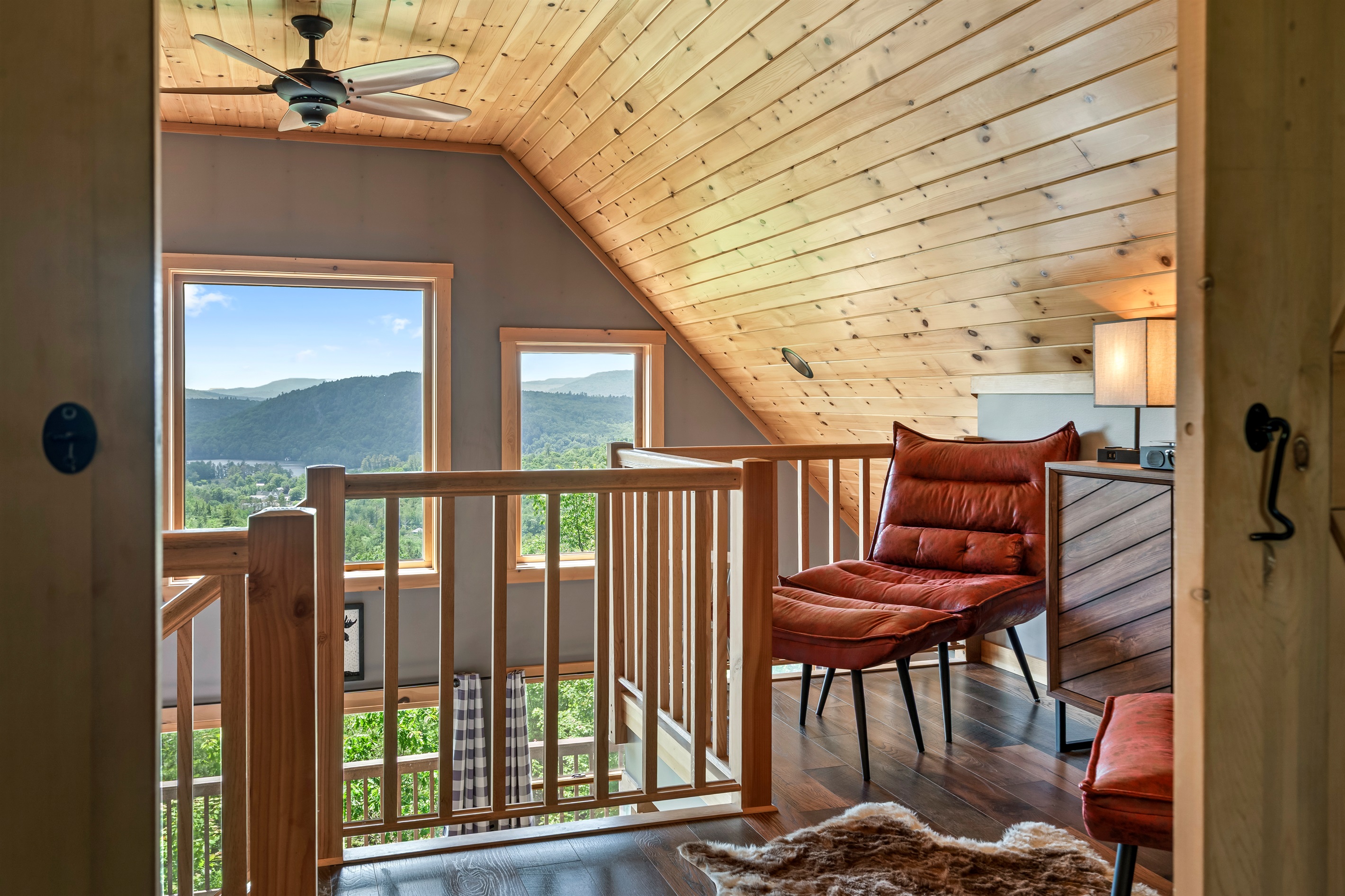 The second floor features a cozy reading loft, the master bedroom with king-size bed and barn door, a work space, and an ensuite bathroom.