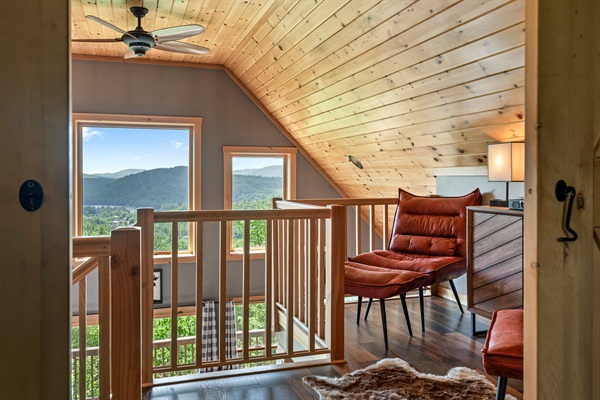 The second floor features a cozy reading loft, the master bedroom with king-size bed and barn door, a work space, and an ensuite bathroom.