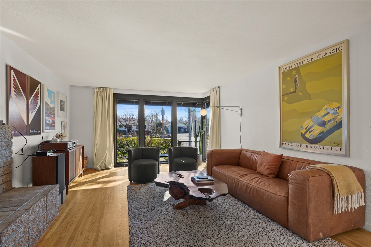 Gather and unwind in the spacious living room featuring comfortable seating, a Smart TV, and an inviting atmosphere perfect for relaxing with family and friends.