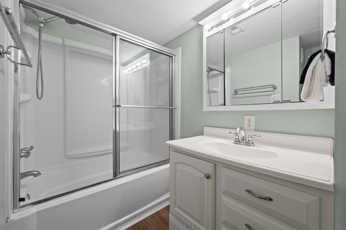 Spacious bathroom with tub and shower combo, perfect for families