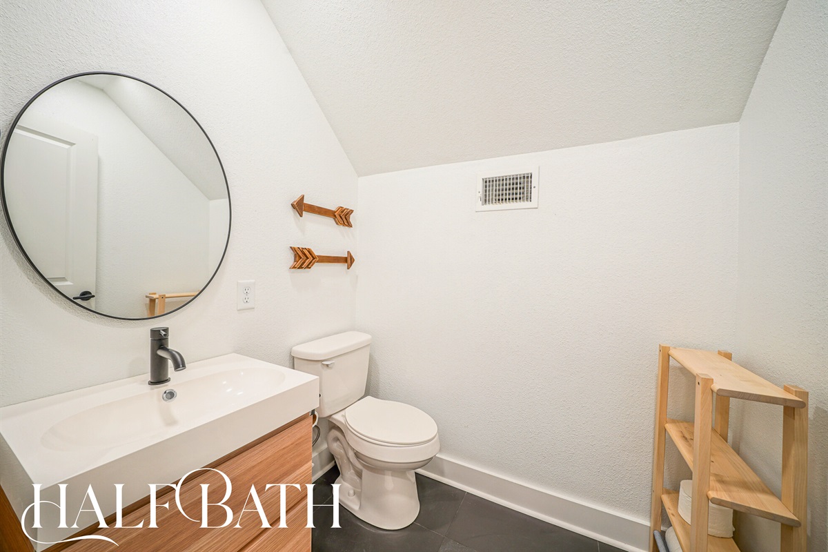 A stylish and convenient half bath just off the main living areas — ideal for quick refreshes without waiting in line.