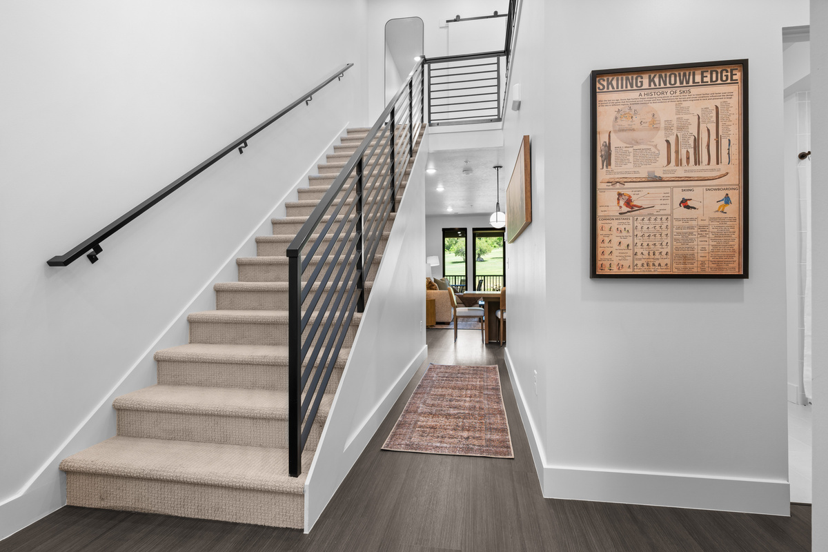 Stairway leading to the spacious upper-level family suite.