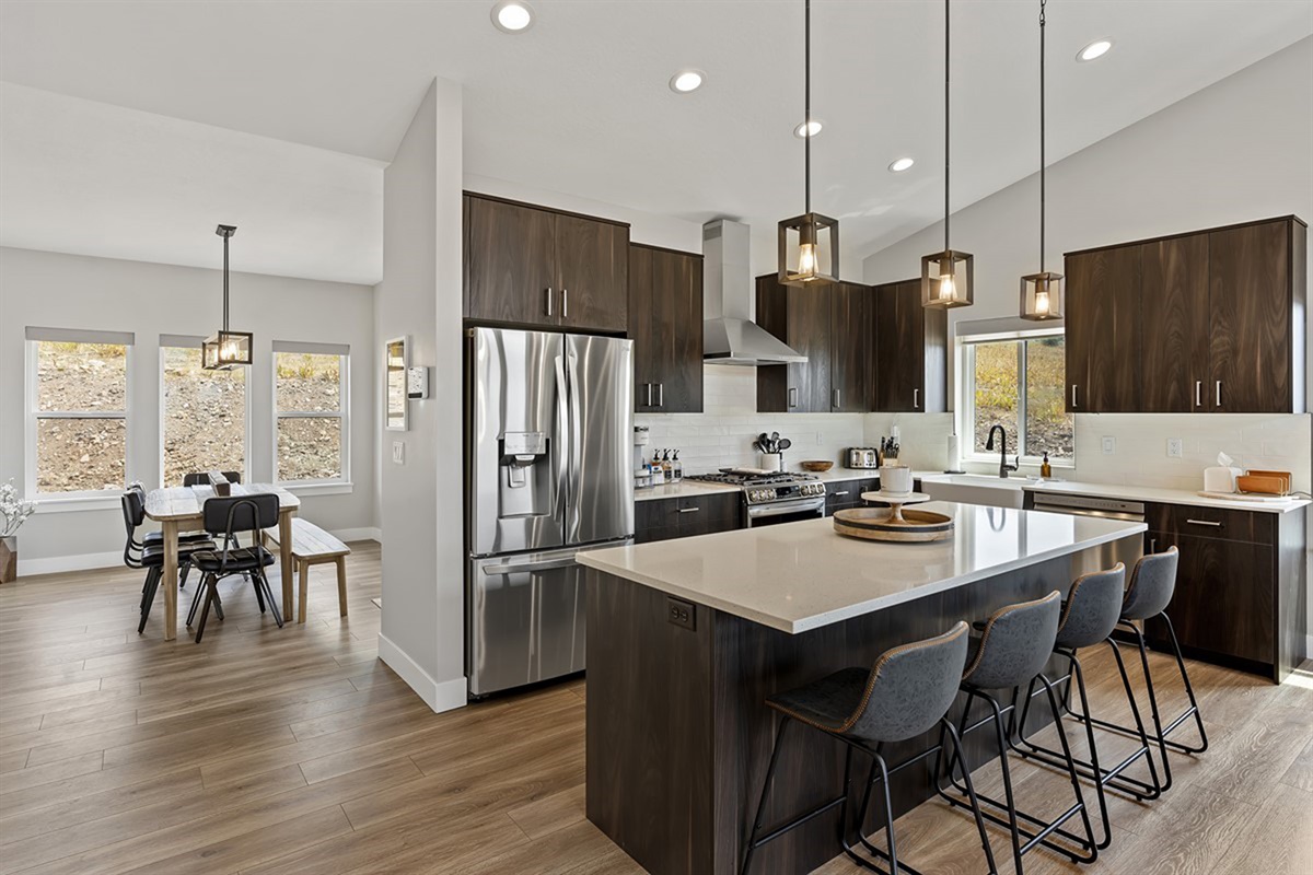 Modern chef’s kitchen with large island, stainless appliances, and open layout