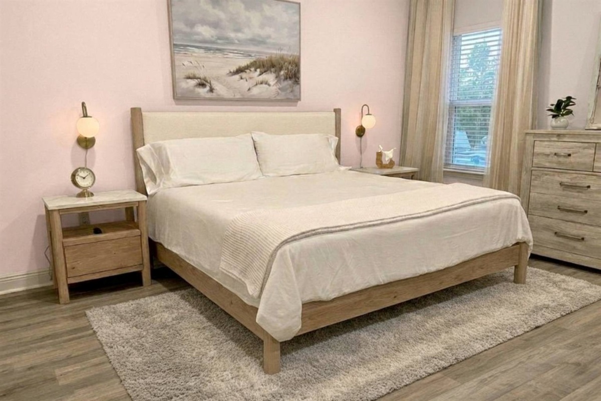 Luxurious primary suite with king bed, walk-in closet, and ensuite bath featuring double vanity.