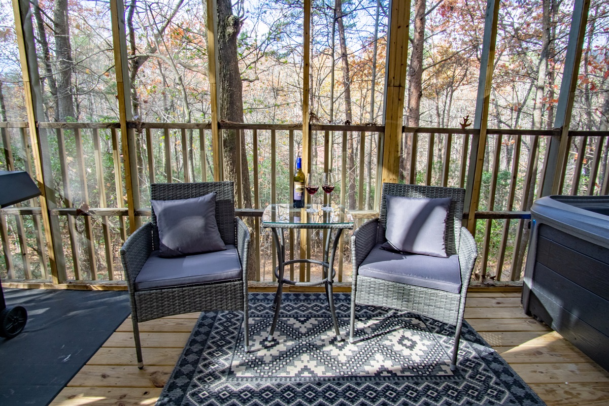Enjoy a glass of wine on the deck while taking in the forest views.