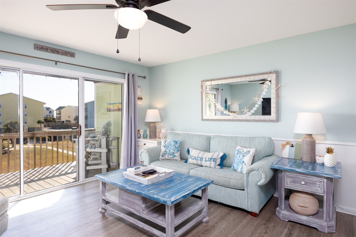 Sun-filled living room with charming beach d&eacute;cor and comfortable seating for the whole family