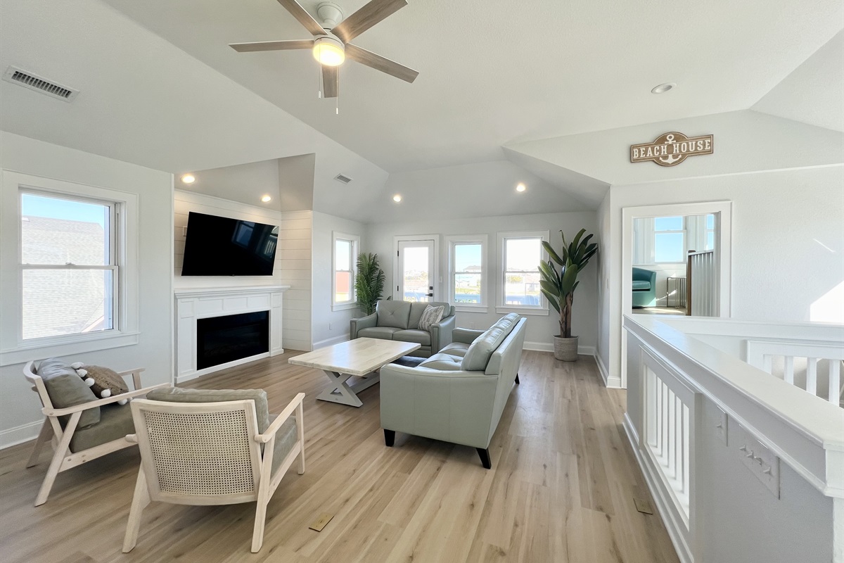 Family room with a ton of windows and views of the ocean