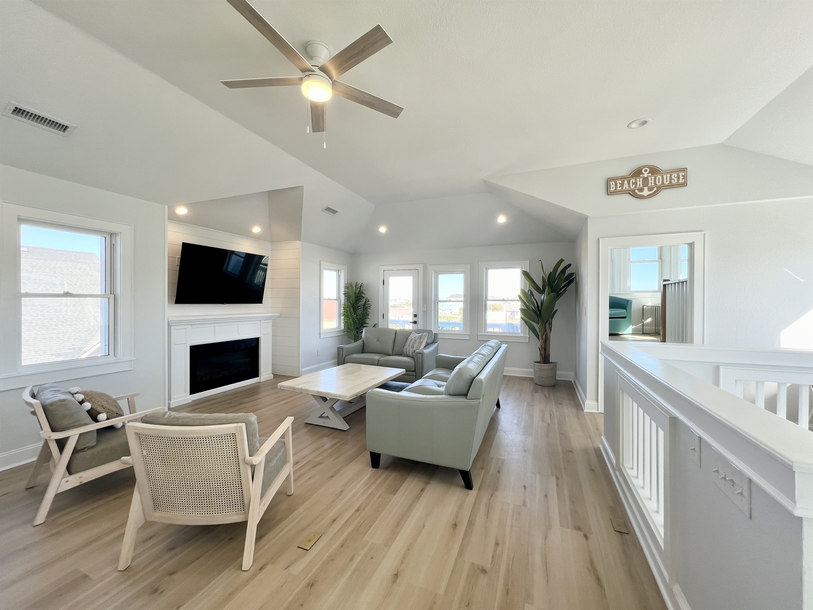 Family room with a ton of windows and views of the ocean