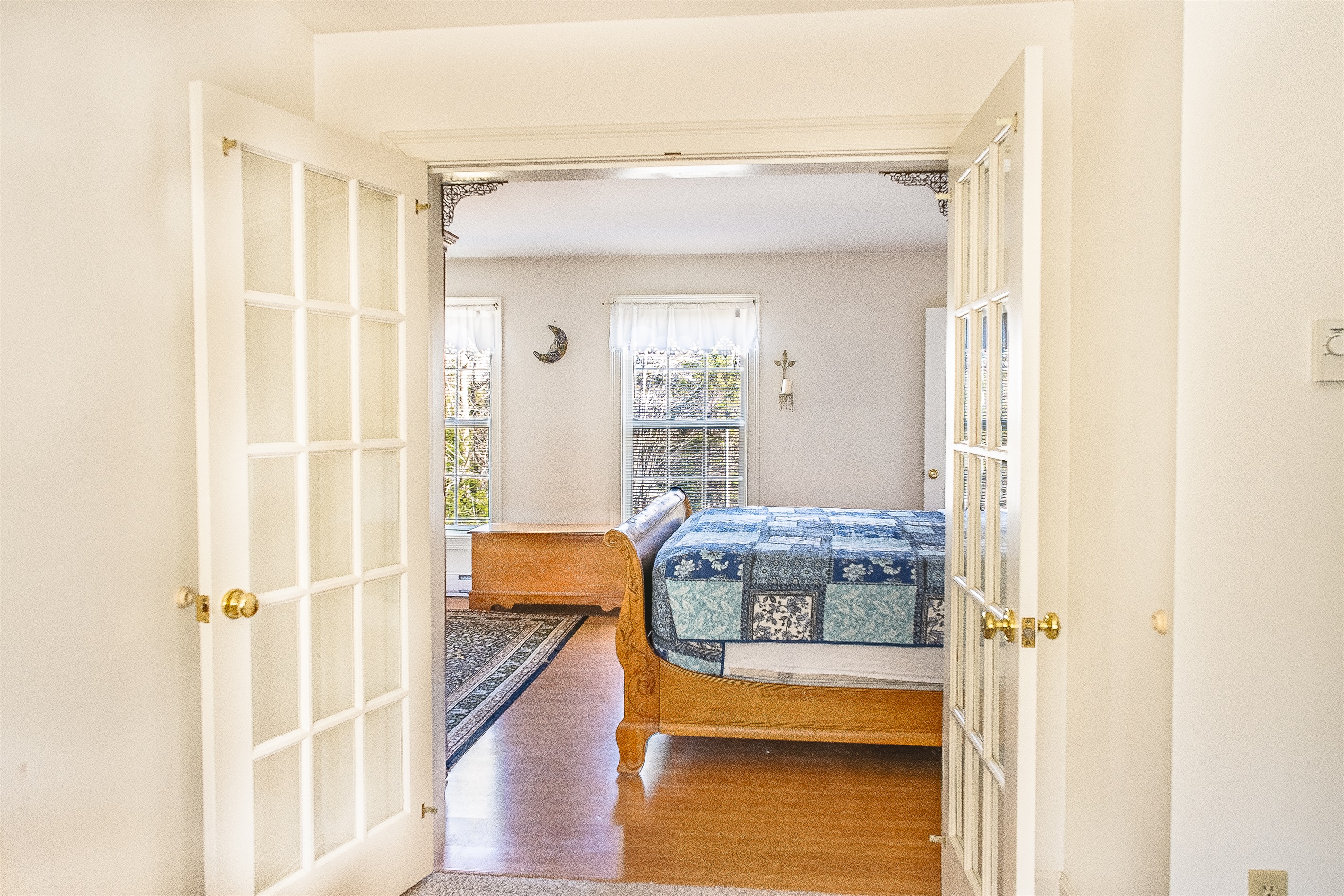 Gaze through the French doors from your private sitting room into the main primary bedroom. This open yet private layout highlights the King sleigh bed and the bright, sun-drenched atmosphere that makes Seven Peaks Ridge a premier retreat.