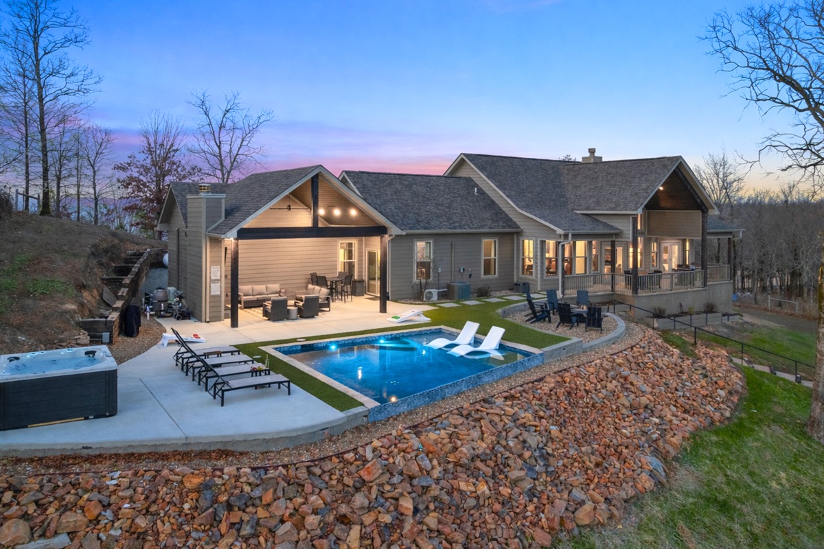 At dusk, the entire property glows warmly against the mountains, creating a picture-perfect mountain retreat.