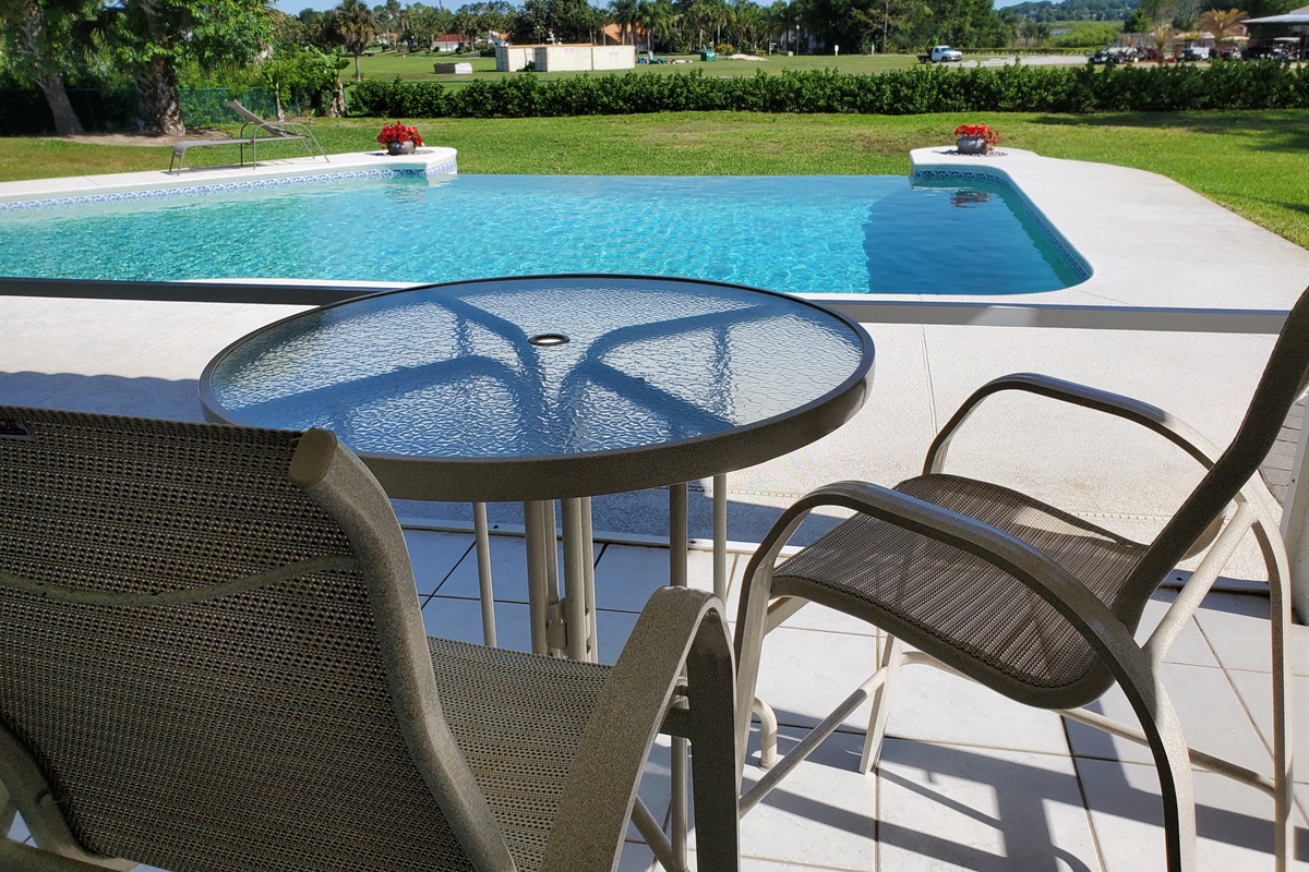 Indoor table and chairs for your morning coffee; golf course view
