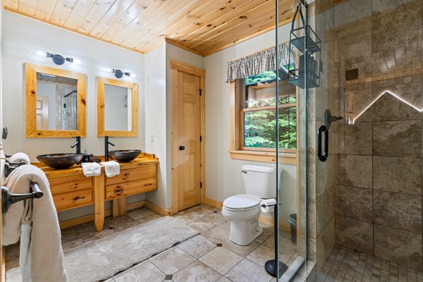 The bathroom includes a standing shower—simple, clean, and convenient.