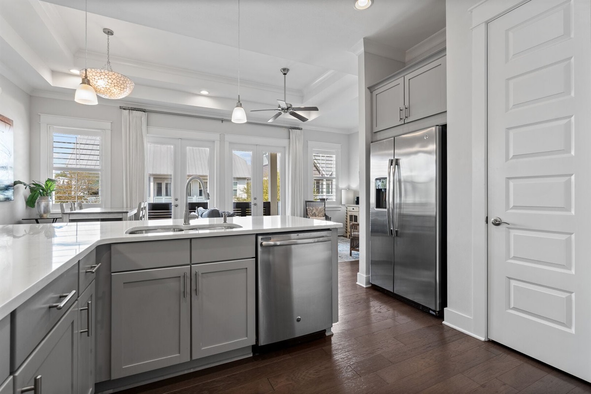 Stainless fridge, dishwasher, and prep sink.