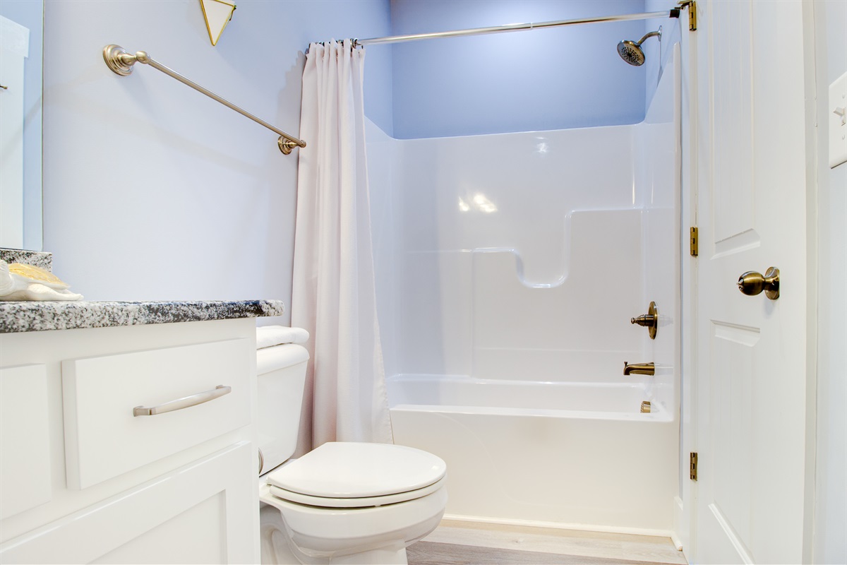 Private tub/shower combo with clean lines and a fresh, hotel-style feel