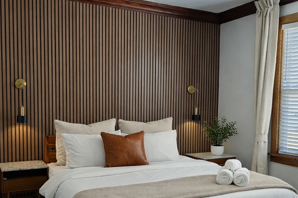Comfort-focused bedroom designed for great sleep—premium linens, blackout. curtains, and a peaceful atmosphere.