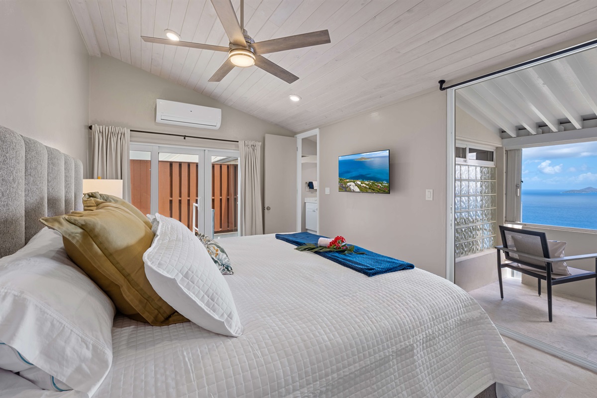 Guest bedroom with king bed, Smart TV, balcony, ceiling fan and ensuite bathroom