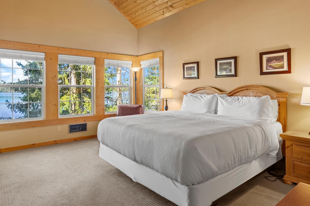 Primary bedroom with king bed and lake views