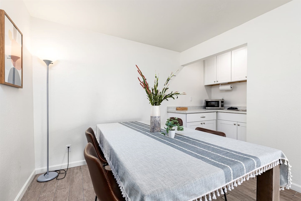 With sleek seating, geometric artwork, and a linen runner, this space is designed for both comfort and style.

