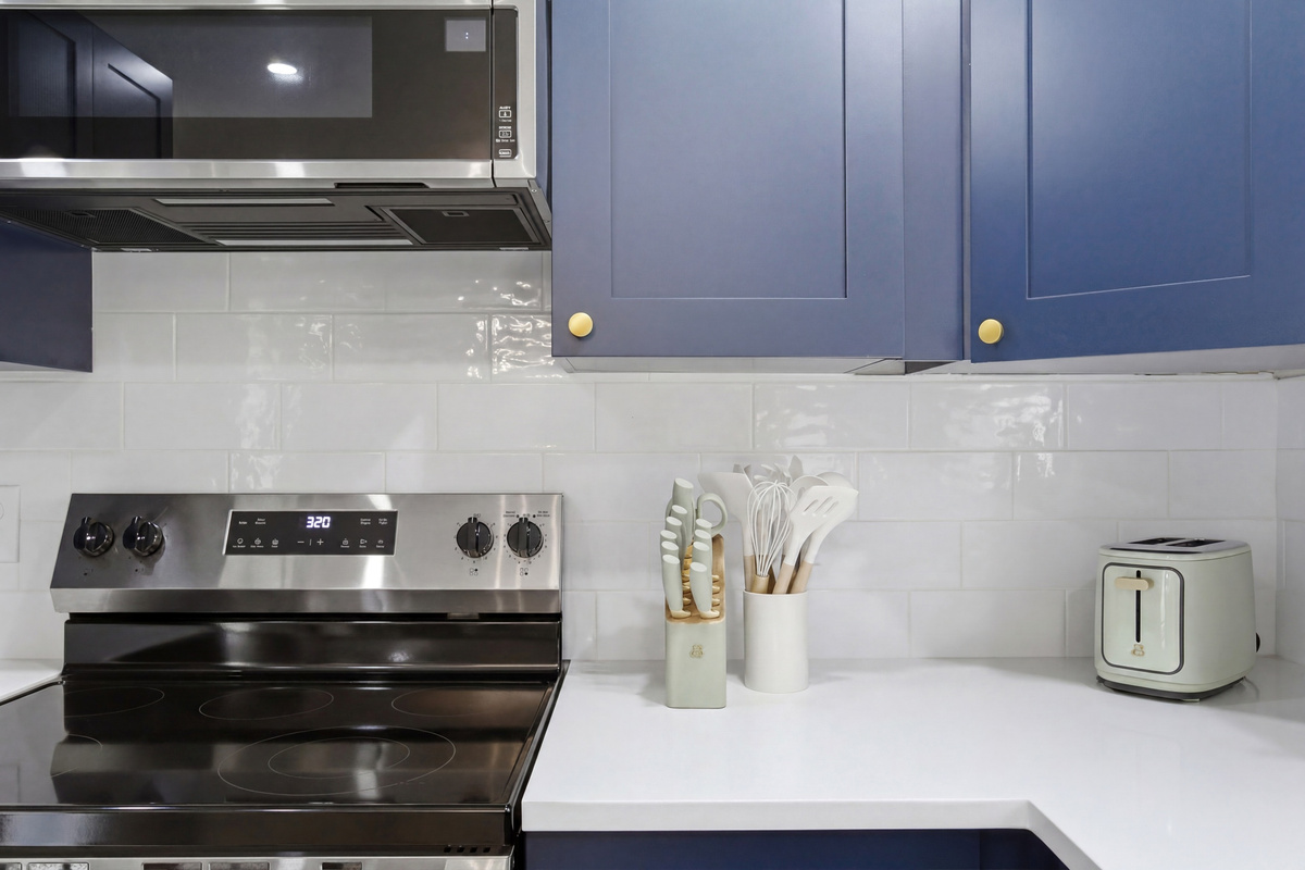 GE Electric Stove and Single Oven with Toaster, Blender, and Cooking Basics on hand. Plenty of counter space for prepping group meals.
